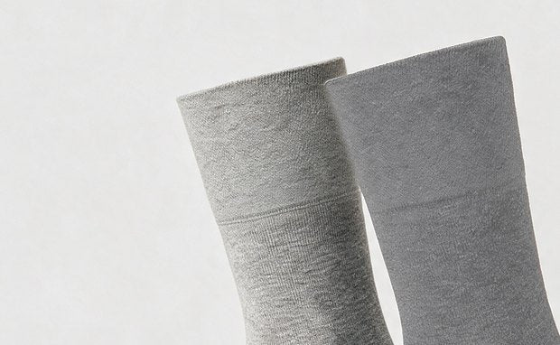In Colors — Gray: a light grey and a mid grey sock, the wide cuff up close